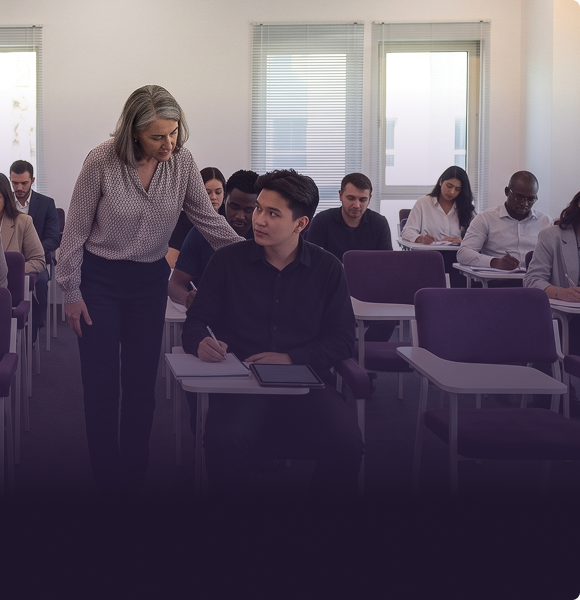 A lecturer supporting a student during class